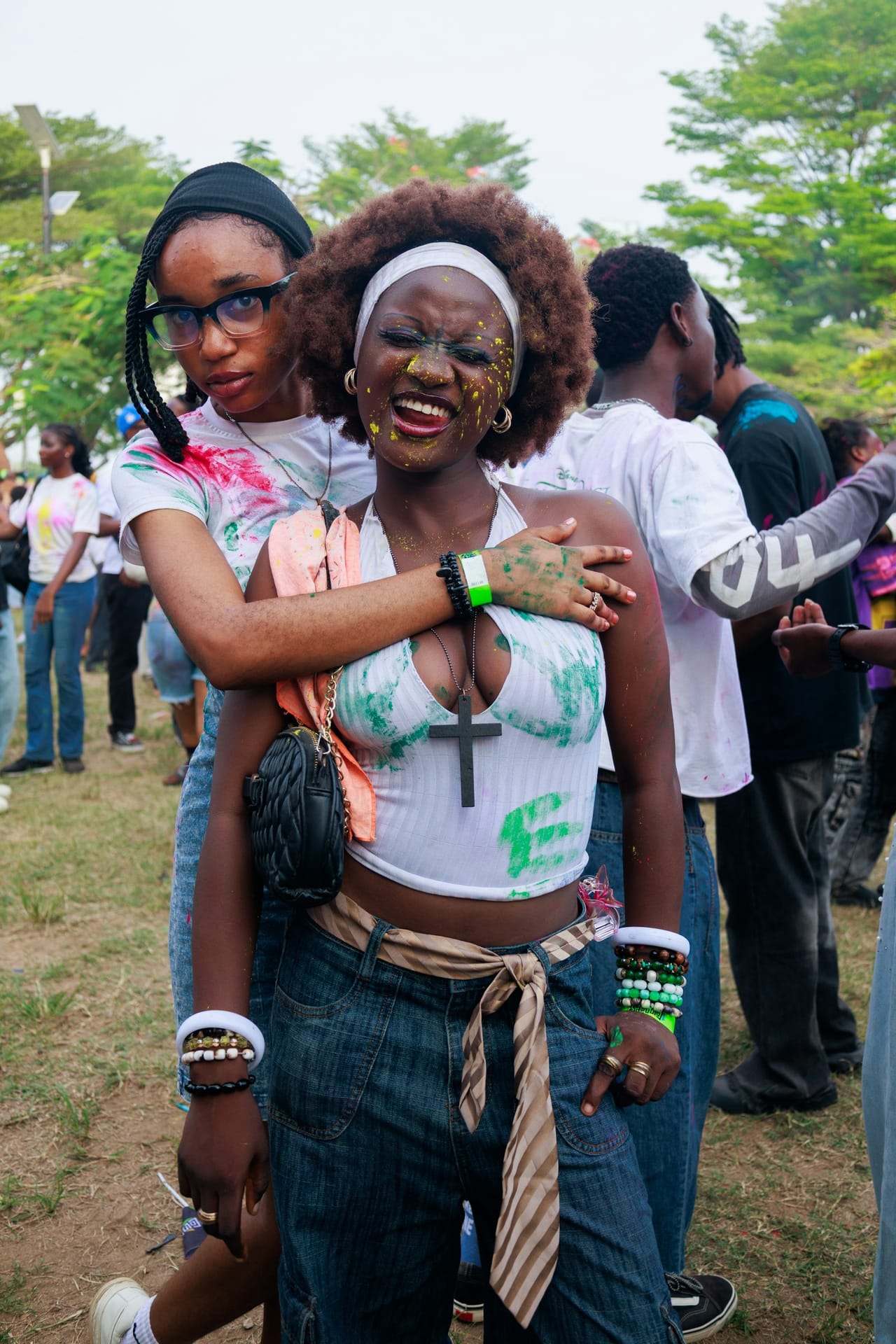 Two friends hugging at an outdoor day party